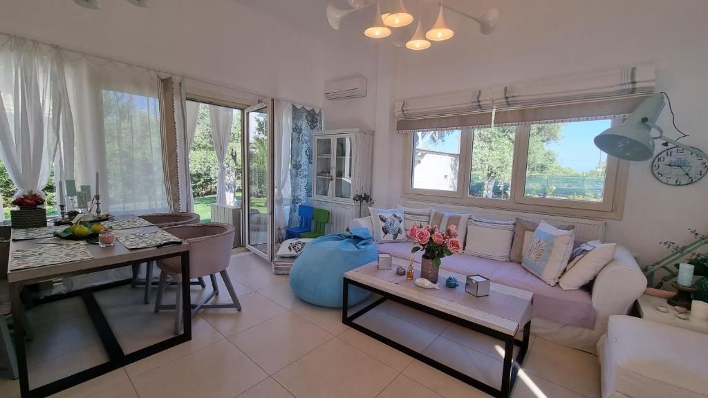 a living room with a couch and a table at Villa Vanya in Skala Rachoniou