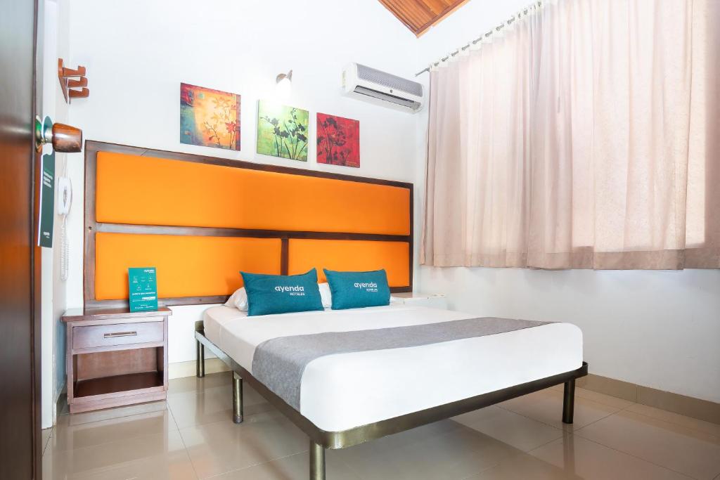 Säng eller sängar i ett rum på Ayenda Mar Azul Neiva