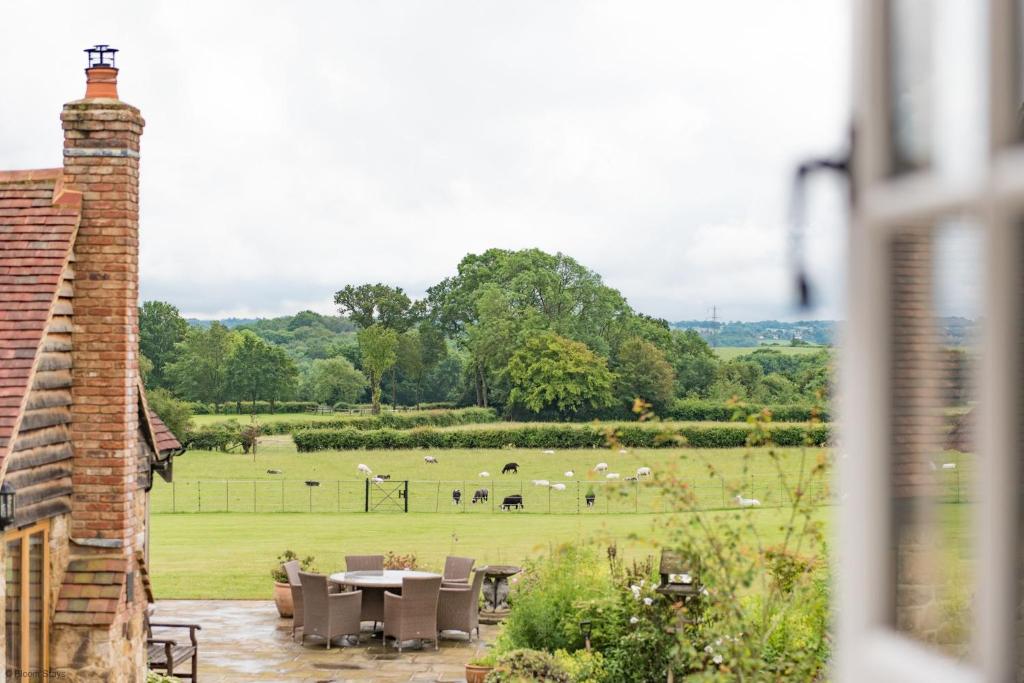 a view of a field with a table and chairs at Motor House Loft by Bloom Stays in Sandhurst