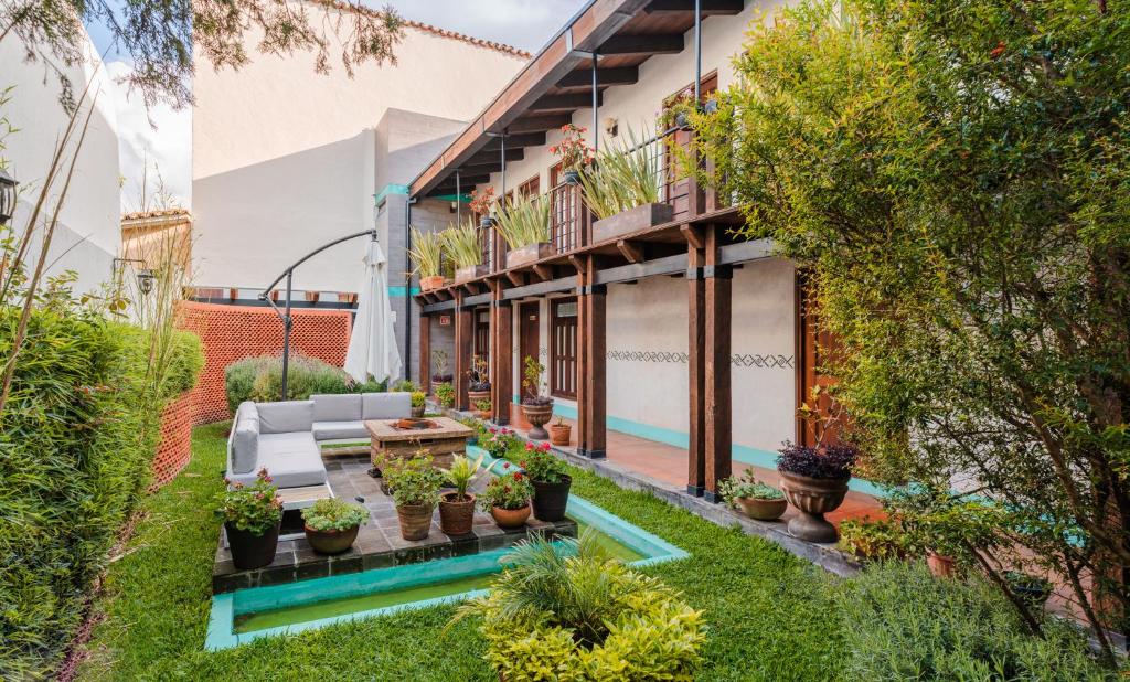an apartment patio with a pool and plants at Yox Hotel Boutique in San Cristóbal de Las Casas