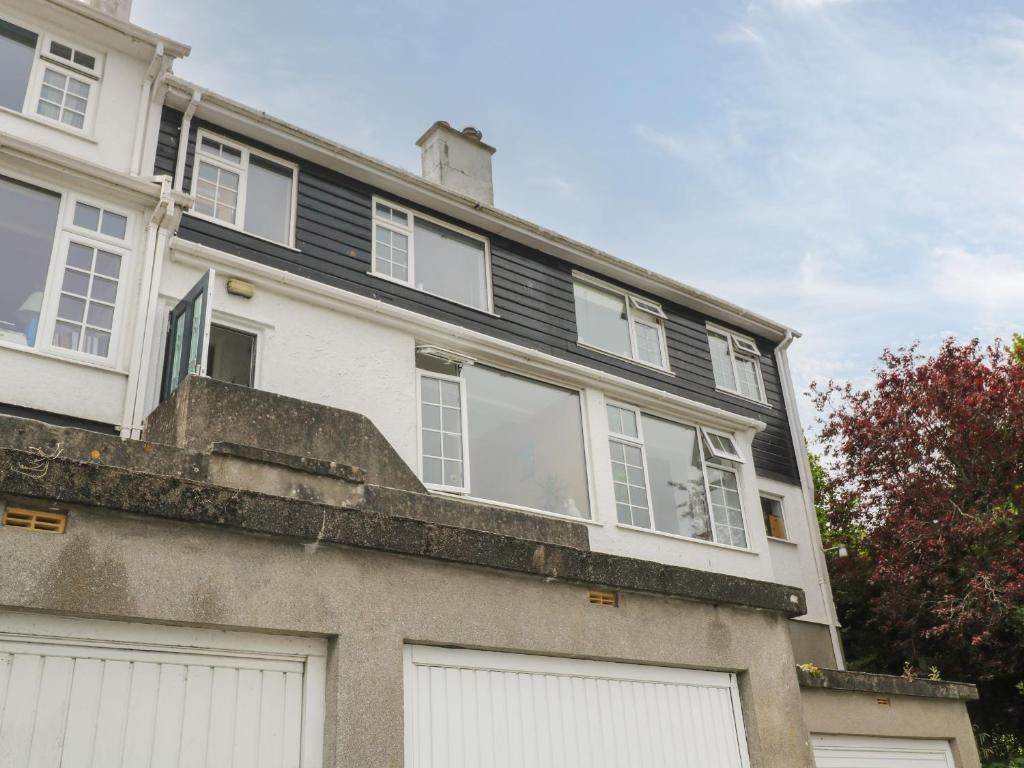 a large white house with white doors and windows at 8 Bowjey Terrace in Penzance