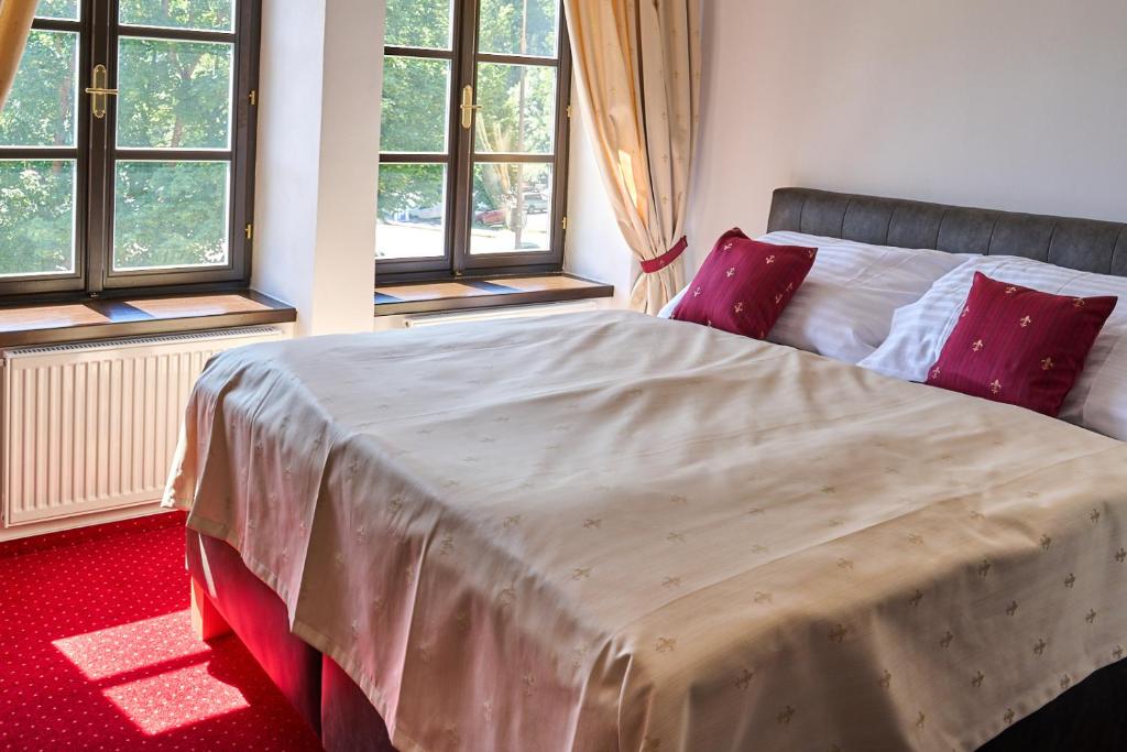 Postel nebo postele na pokoji v ubytování Vila Lovců králových