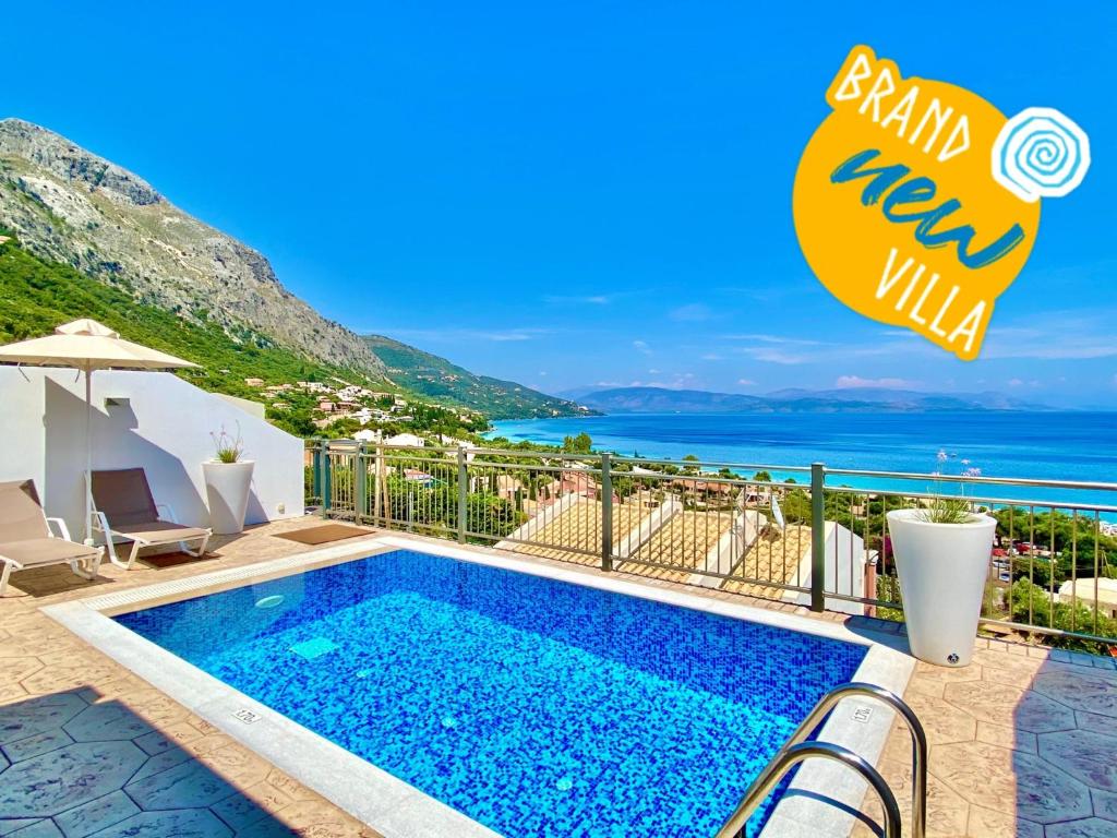 a villa with a swimming pool and a view of the ocean at Luxury Villa Akti Barbati 2 with private pool in Ano Pyrgi