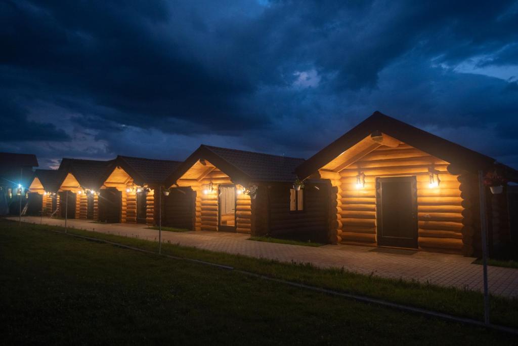 a row of wooden lodges at night at Christiana-Rent in Cristian