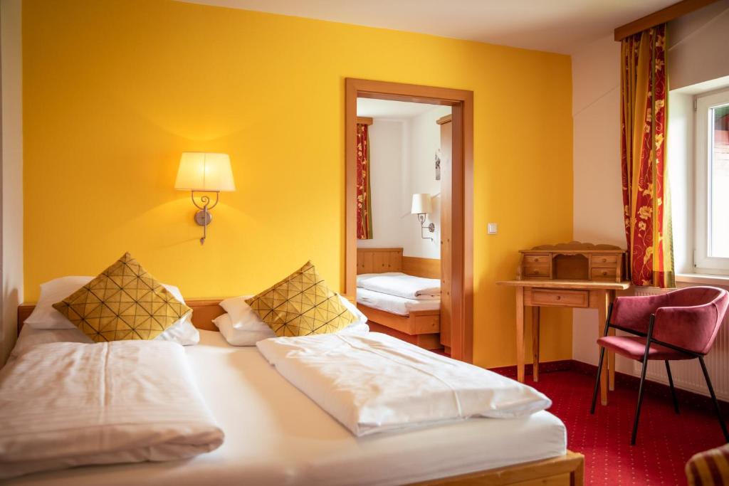 Postel nebo postele na pokoji v ubytování Hotel Restaurant tauernhex