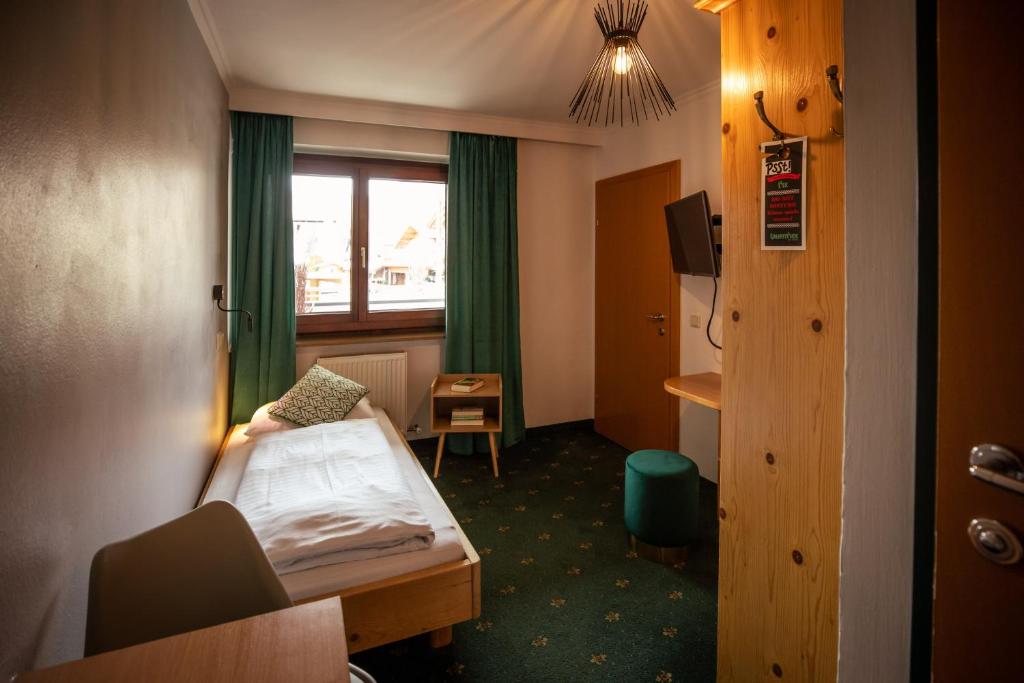 Postel nebo postele na pokoji v ubytování Hotel Restaurant tauernhex