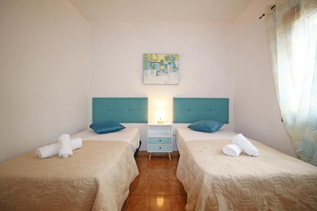 A bed or beds in a room at Residencial Tropicana