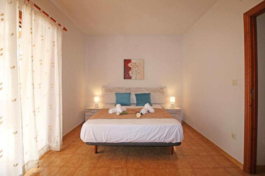 A bed or beds in a room at Residencial Tropicana