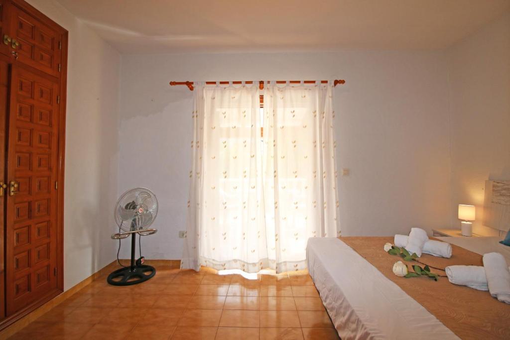 A bed or beds in a room at Residencial Tropicana