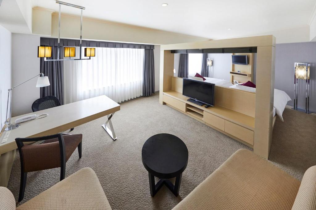 a hotel room with a desk and a bed at ANA Crowne Plaza Kanazawa by IHG in Kanazawa