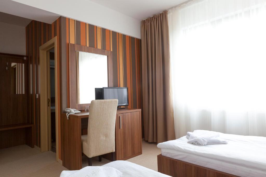 Postel nebo postele na pokoji v ubytování Hotel Mariss