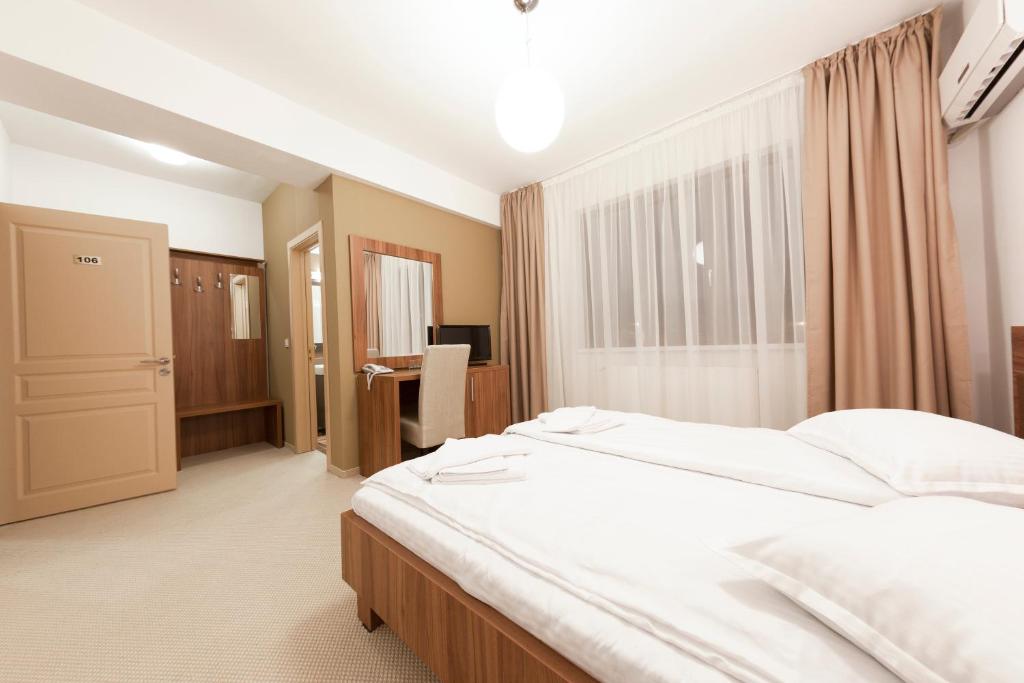 Postel nebo postele na pokoji v ubytování Hotel Mariss