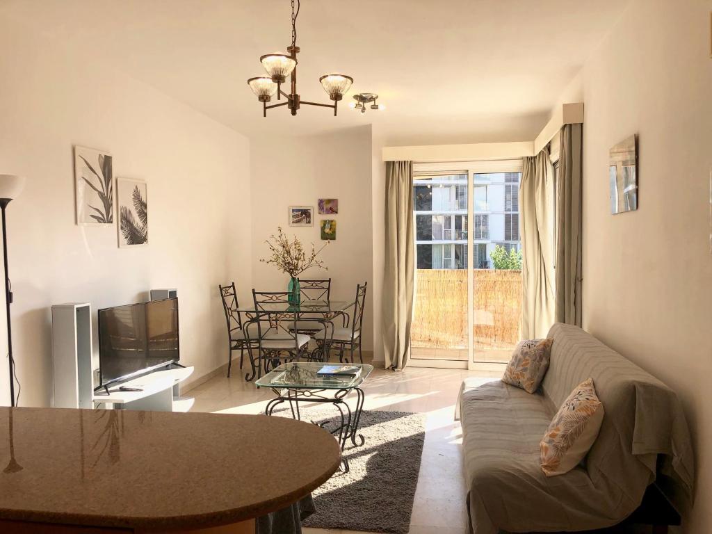 a living room with a couch and a table at 1 bedroom flat, prime location near sea, sleeps 4 in Limassol