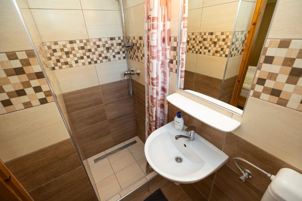 a bathroom with a sink and a shower at Cecey Apartman in Eger