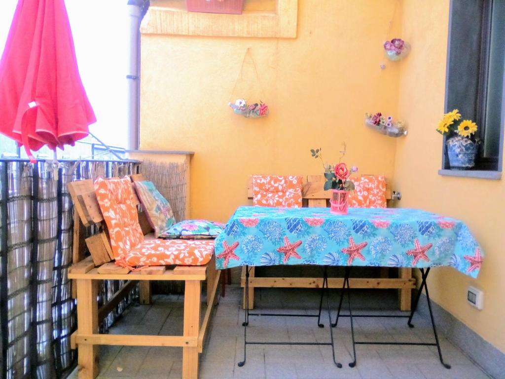 a table and chairs in a room with a table and a tablecloth at Click Center Apartment in Catania