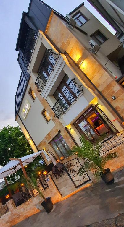 a large building with tables and chairs in front of it at Summer Love in Mangalia
