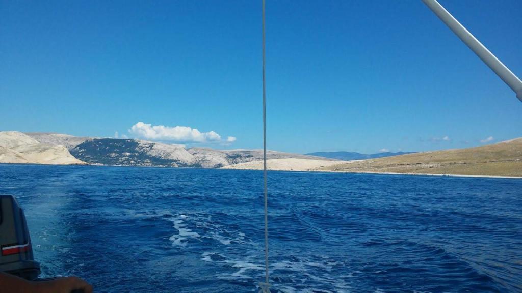 a view from the side of a boat in the water at Apartman Dinka in Baška