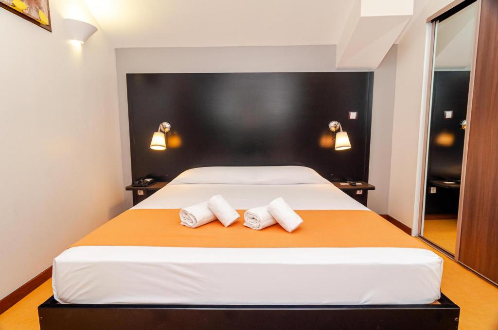 Postel nebo postele na pokoji v ubytování Tama Hotel