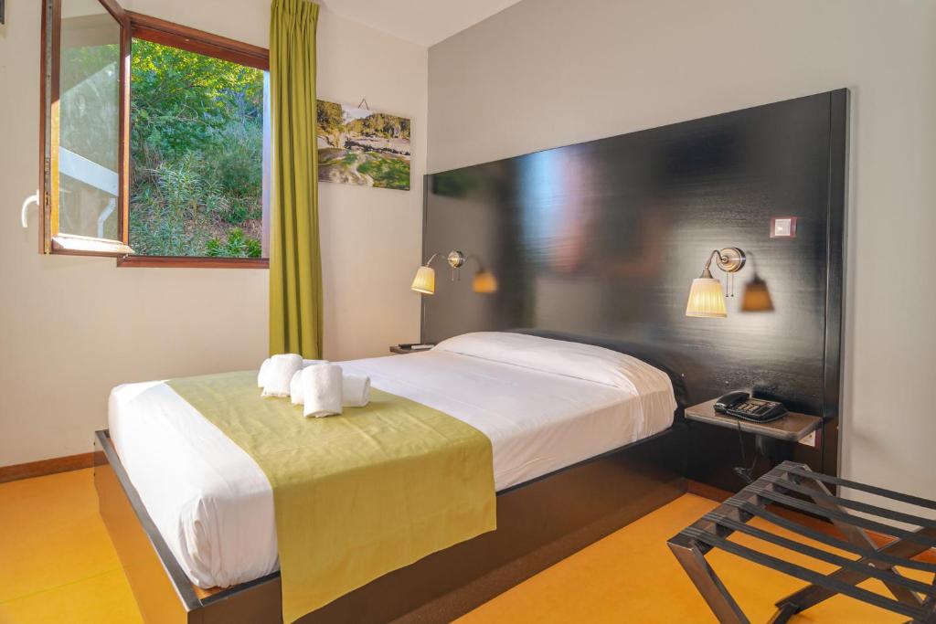 Postel nebo postele na pokoji v ubytování Tama Hotel