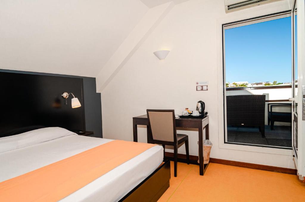 Postel nebo postele na pokoji v ubytování Tama Hotel