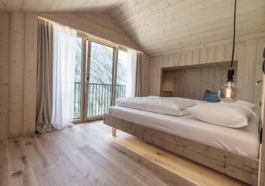 Postel nebo postele na pokoji v ubytování Chalet Tschogerhof Tiers am Rosengarten Dolomiten