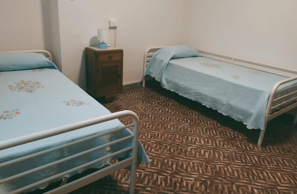 Łóżko lub łóżka w pokoju w obiekcie CASA SILVANA