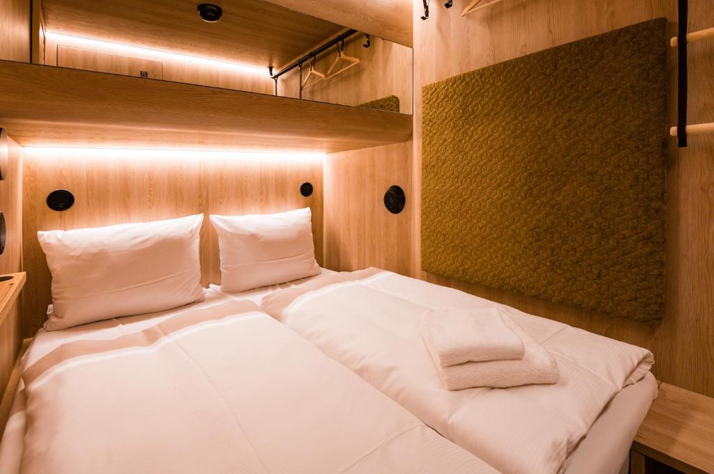 a bedroom with a bed with white sheets and pillows at CAB20 in Hamburg
