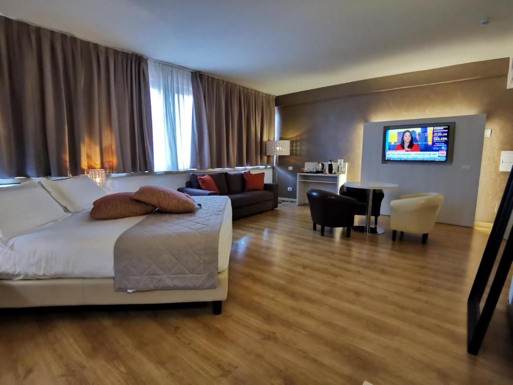 a hotel room with a bed and a living room at Hotel President in Prato