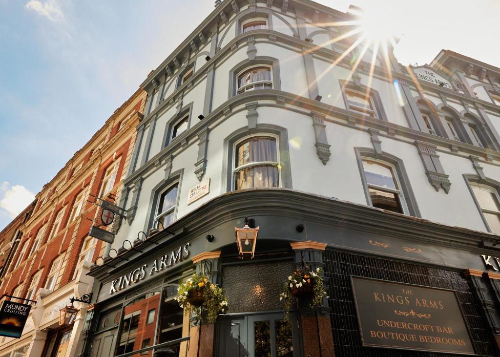 a large white building with the sun shining on it at The Kings Arms Pub & Boutique Rooms in London