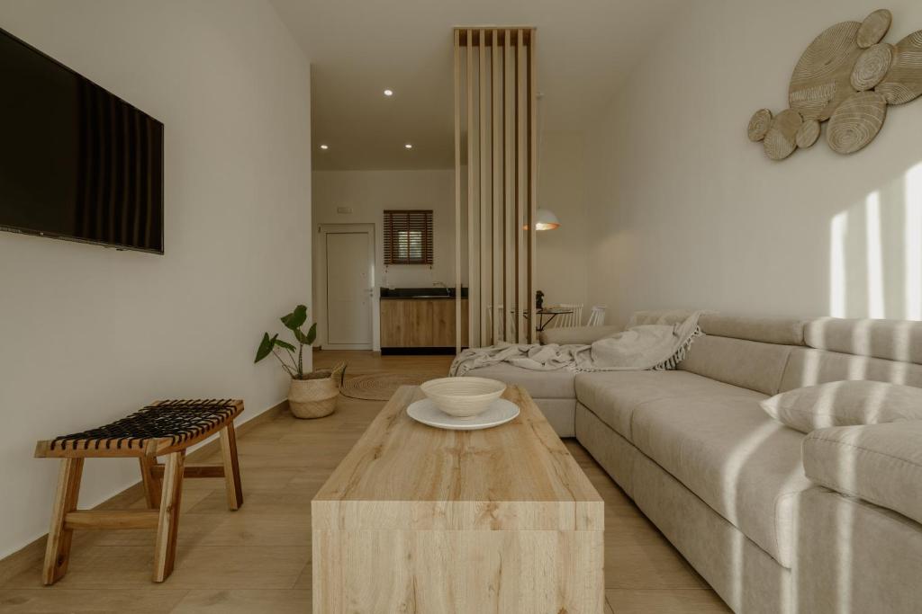 a living room with a couch and a coffee table at Casa Costa Suites in Kanali