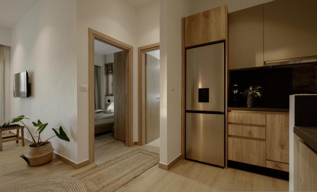 a living room with a television and a sliding door at Casa Costa Suites in Kanali