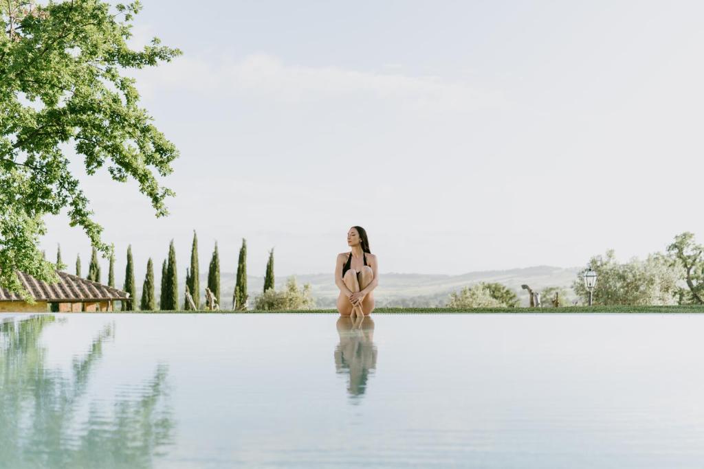 a woman in a bikini standing in the water at Terenzi Hospitality & Wine in Scansano
