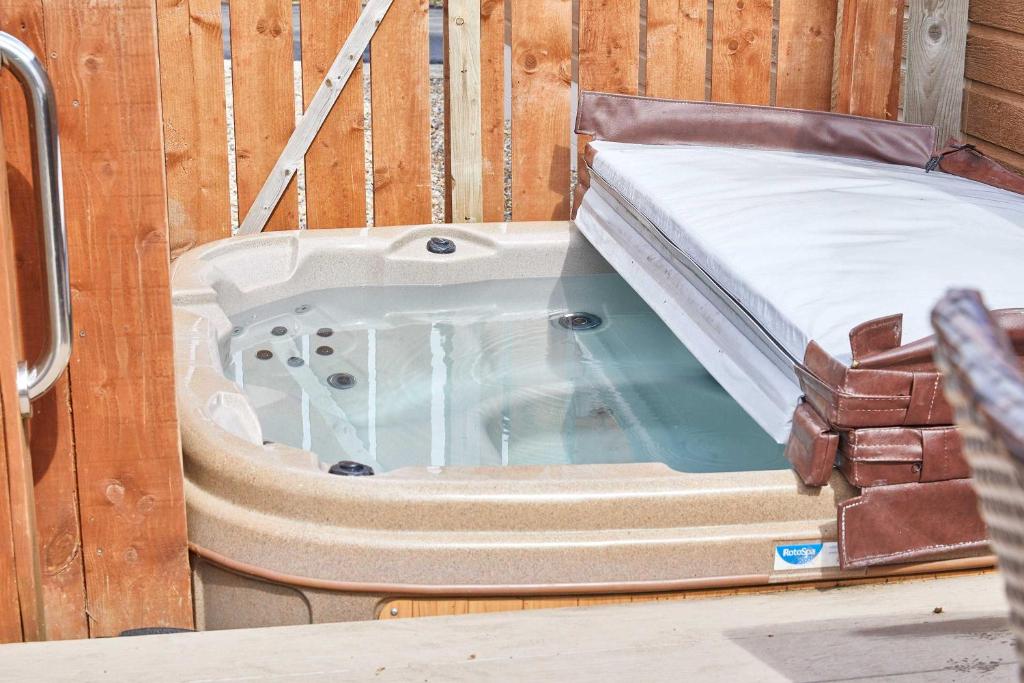 a hot tub with a bed in a wooden wall at Host & Stay - Yolo Lodge in Felton