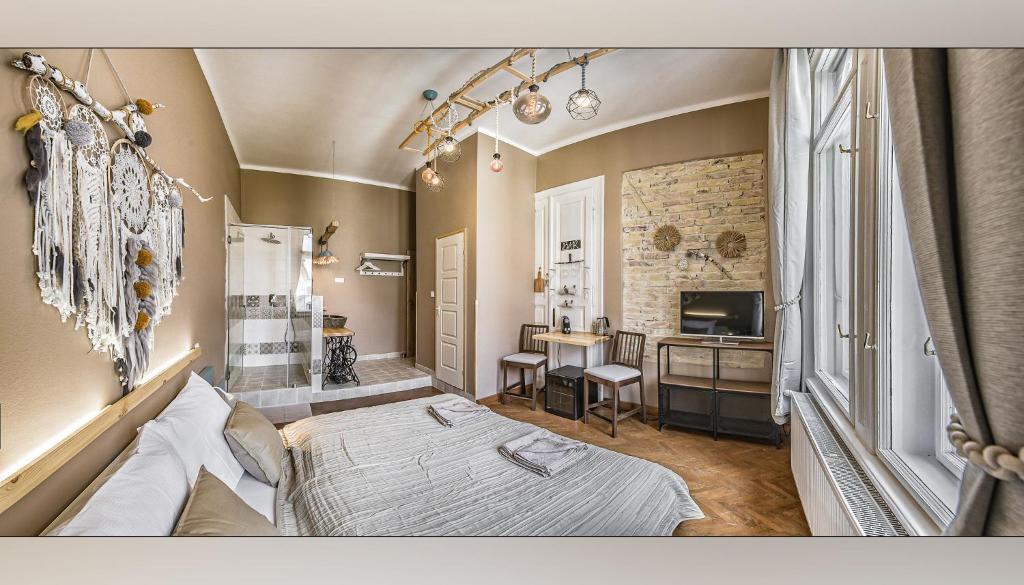 Postel nebo postele na pokoji v ubytování Boutique Suites Ráday