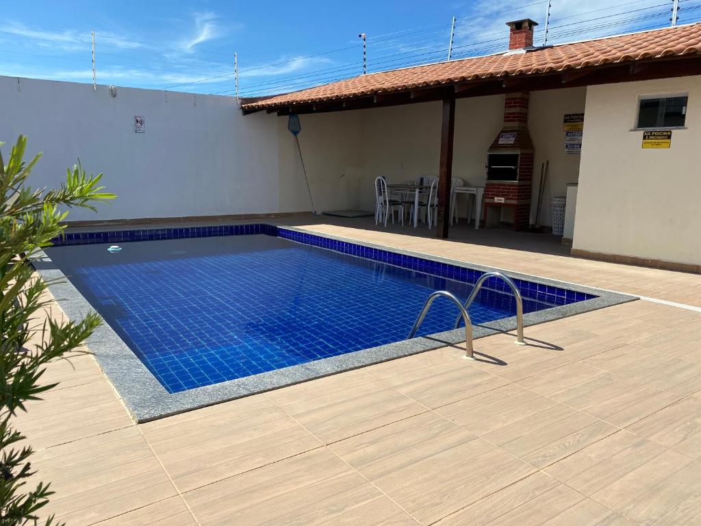 a swimming pool in front of a house at Minha casa, sua casa in Porto Seguro