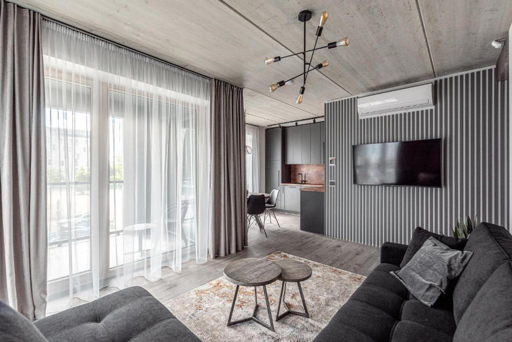a living room with a couch and a tv at Urban center apartment in Vilnius