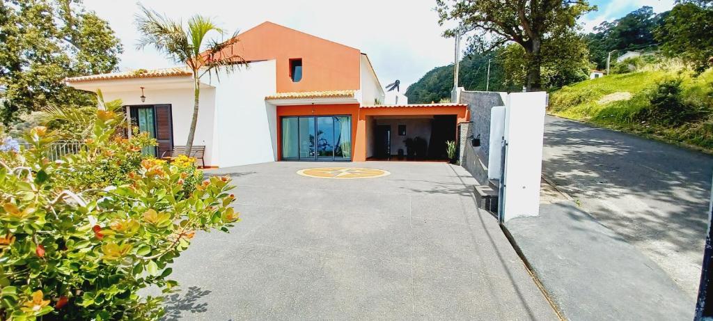 a house on a street with a driveway at Villa Luz - Family House Vacations- Large Private Outdoor Area in Santa Cruz