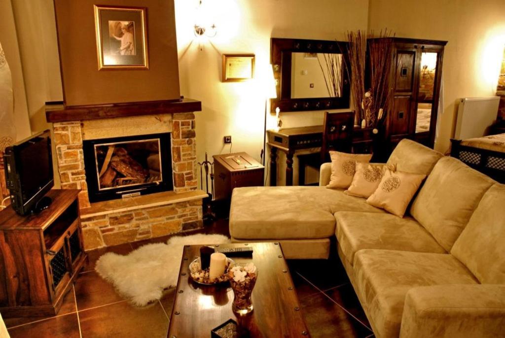 salon z kanapą i kominkiem w obiekcie Luxury Guesthouse Pantheon w mieście Palaios Panteleimon