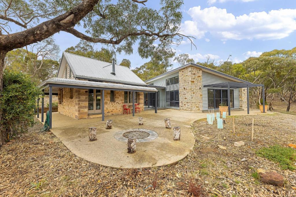 a stone house with a garden in front of it at Benny's Retreat Luxury Bushland Escape in Clare