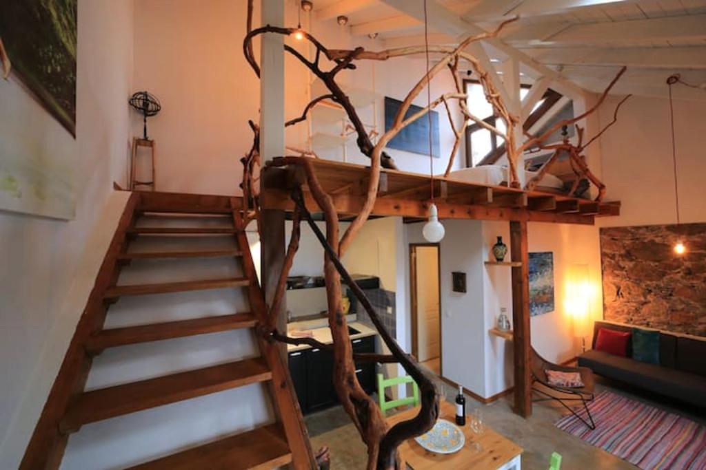 a loft bed with a staircase in a room at Casa Buenavida in Alajeró