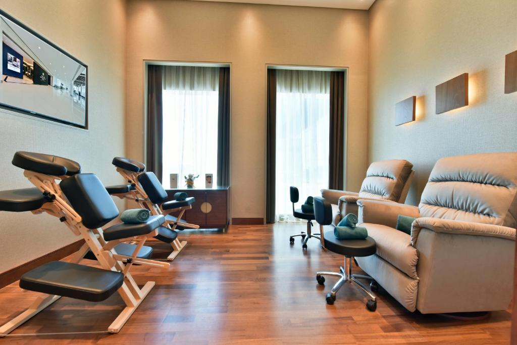a therapy room with chairs and a therapy at Bahrain Airport Hotel Airside Hotel for Transiting and Departing Passengers only in Muharraq