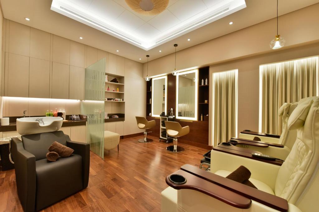 a living room with a couch and a chair at Bahrain Airport Hotel Airside Hotel for Transiting and Departing Passengers only in Muharraq