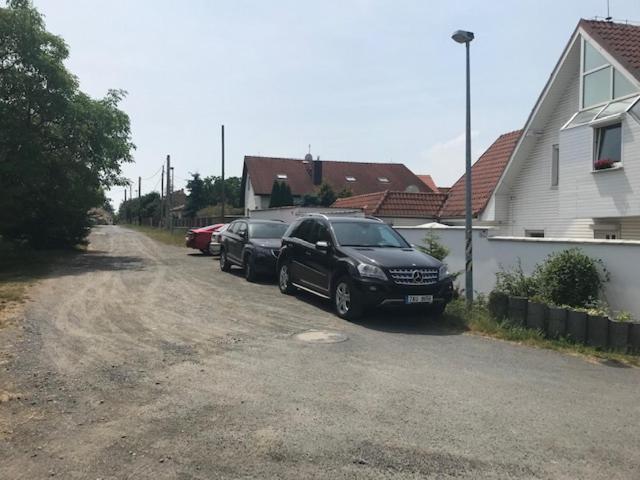 two cars parked in a driveway next to a house at Homestay U Hanky in Zdiby