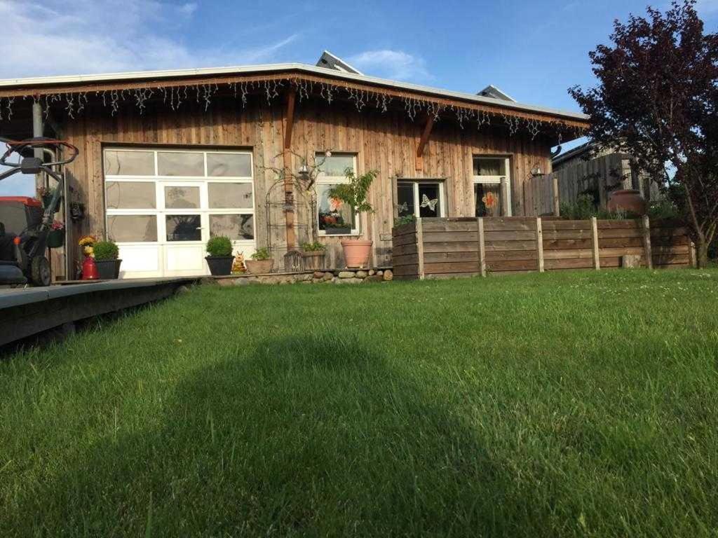 a house with a green lawn in front of it at Ruegen Fewo 66 2 in Kasnevitz