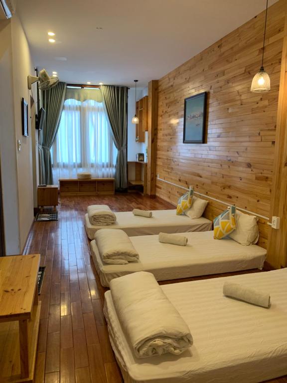 a group of four beds in a room at Gallery homestay in Quy Nhon