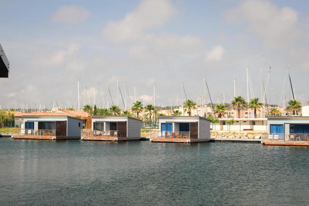 a row of houses in a harbor with boats at Les Ilots de Gruissan in Gruissan