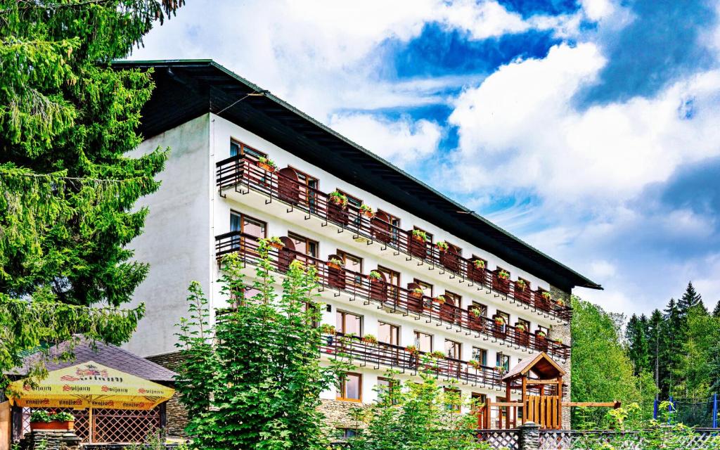 a building with balconies on the side of it at Hotel Stella in Železná Ruda