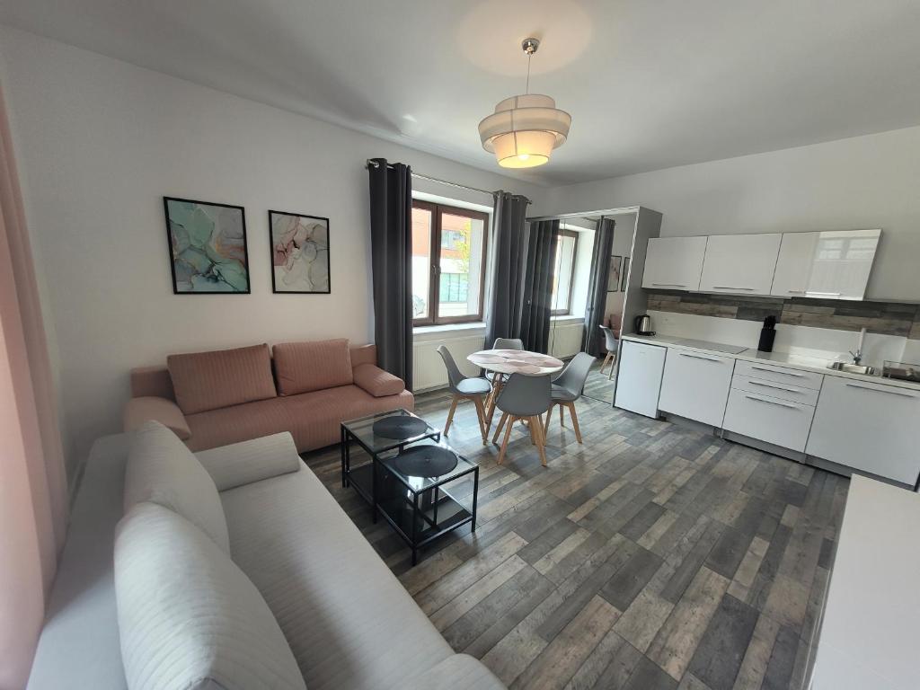 a living room with a couch and a table at Apartamenty Chopina 1 in Bydgoszcz