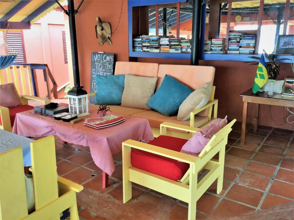 a living room with a couch and a table and chairs at The Sweet Retreat in Port Elizabeth