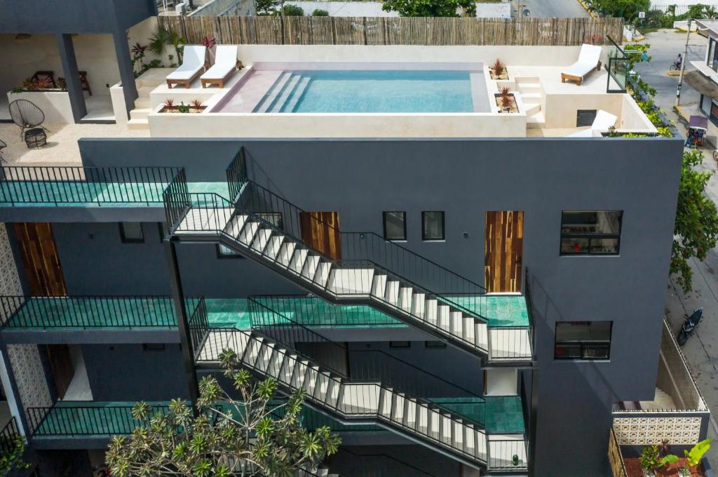an aerial view of a building with a swimming pool at UJO Condo Boutique in Tulum